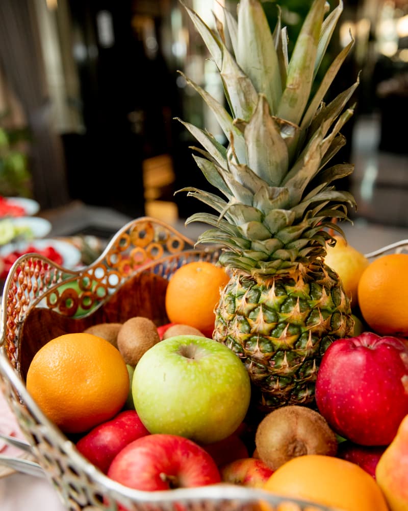 Fresh Natural Fruits - Vibrant Fruit Basket with Pineapples, Oranges, Apples, and Kiwis